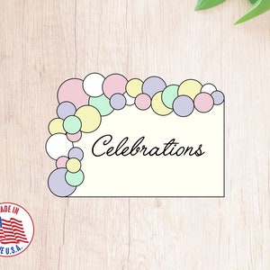 May include: A printable sign with the word "Celebrations" in cursive script. The sign is decorated with a pastel balloon arch made of pink, yellow, green, and purple balloons.