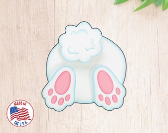 May include: White bunny cookie cutter with a fluffy tail and pink feet. The cutter is made in the USA.