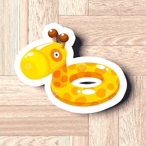 May include: A yellow and orange inflatable pool float shaped like a giraffe with brown ears and a blue eye. The float has a white outline and is on a wood background.
