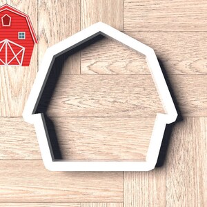 May include: White plastic cookie cutter shaped like a barn with a simple design.
