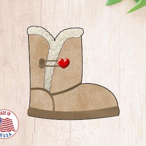 May include: A brown faux fur boot with a red heart detail. The boot is a cookie cutter.