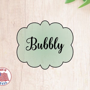 May include: A green cloud-shaped cookie cutter with the word "Bubbly" written in black cursive font. Made in the USA.