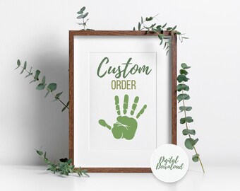 May include: A framed print with the words "Custom Order" and a green handprint. A small, round sticker with the words "Digital Download" is in the lower right corner. Eucalyptus sprigs are arranged around the frame.