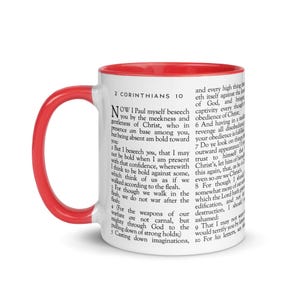 May include: White ceramic mug with a red interior and handle. The mug features text from 2 Corinthians 10. A perfect gift for those seeking inspiration or a daily reminder of faith.