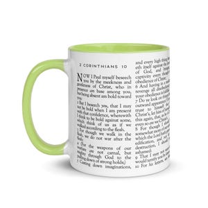 May include: White ceramic mug with a light green interior and handle. The mug features text from 2 Corinthians 10. A perfect gift for anyone who enjoys reading the Bible or drinking coffee.