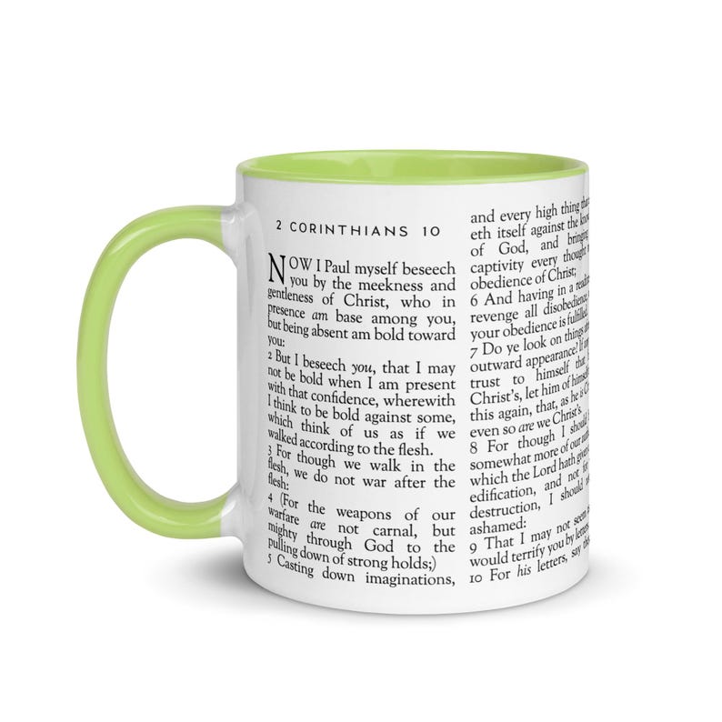 May include: White ceramic mug with a light green interior and handle. The mug features text from 2 Corinthians 10. A perfect gift for anyone who enjoys reading the Bible or drinking coffee.