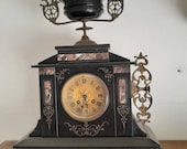 Antique black marble table clock, pink, green and gray marble inlays.
