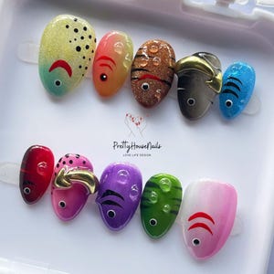 fish nail art, ocean theme nails, colorful press on, cute fake nails, kawaii nail set, summer nail design, handmade press on, festival nail art, fun nail designs, aquatic nail set, quirky fake nails, rainbow press on, unique nail art, holiday nails, party nails, short oval nails