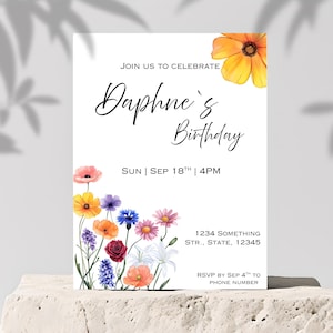 May include: A white invitation card with a floral design featuring a variety of colorful flowers. The text on the card reads "Join us to celebrate Daphne's Birthday, Sun Sep 18th | 4PM, 1234 Something Str., State, 12345, RSVP by Sep 4th to Phone Number".