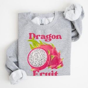 May include: Gray sweatshirt with a pink and green dragon fruit graphic and the text "Dragon Fruit" in pink.