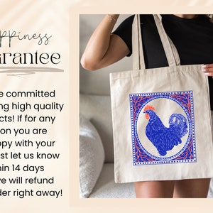 May include: A white tote bag with a blue rooster illustration inside a red and blue frame. The text "Happiness Guarantee" is on the left side of the image. The text below the image reads: "We are committed to offering high quality products! If for any reason you are unhappy with your item, just let us know within 14 days and we will refund your order right away!"