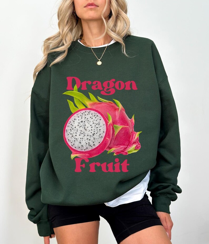 May include: A dark green sweatshirt with a pink and white dragon fruit graphic and the text "Dragon Fruit" in pink.