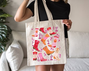 May include: A beige tote bag with a colorful pattern of cowboy boots, cacti, and stars. The text "Yee Haw" is repeated on the bag.