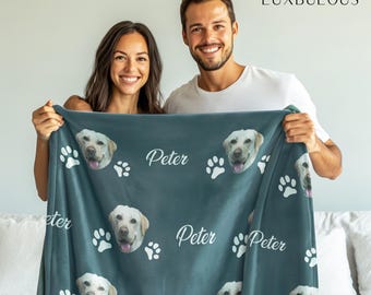 May include: A teal blue fleece blanket with a repeating pattern of white paw prints and a dog's face. The dog's face is a photo of a golden retriever. The blanket has the name "Peter" printed on it multiple times.