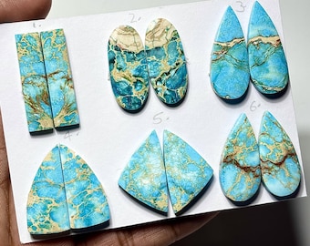 May include: A collection of six pairs of polished gemstones in various shapes, including rectangles, ovals, teardrops, and triangles. The stones feature a vibrant turquoise base color with brown and cream-colored veining, creating a unique pattern.