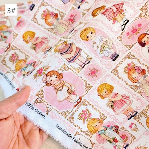 May include: White cotton fabric with a repeating pattern of girls in pink dresses and gold frames. The fabric has the text "100% Cotton, Handmade Fabric, Inc." printed on the edge.