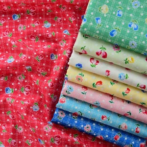 May include: A collection of floral fabric in various colors, including red, green, yellow, and blue. The fabrics feature a repeating pattern of flowers and leaves, with a grid-like design. The fabrics are stacked, showcasing the different colors and patterns.