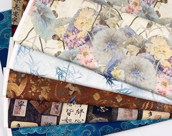May include: Six different fabric swatches with Asian-inspired designs. The top swatch features a light beige background with watercolor-style pink and purple flowers and large green leaves. The second swatch is light blue with a watercolor-style bamboo design. The third swatch is a dark brown with a gold and brown bird pattern. The fourth swatch is a dark blue with a black and white pattern of Chinese characters and seals. The fifth swatch is a dark blue with a white cloud pattern. The sixth swatch is a dark blue with a white cloud pattern.