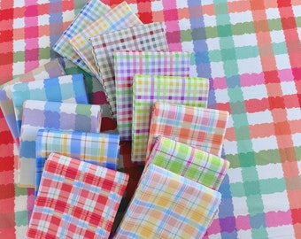 May include: A collection of folded fabric squares in various pastel colors, featuring a classic gingham pattern. The fabrics are arranged on a larger gingham patterned surface, creating a cohesive and colorful display.