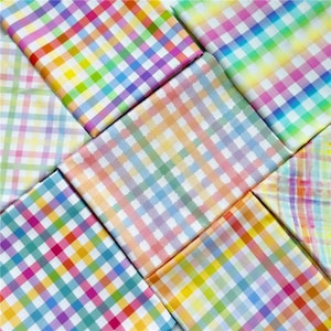 May include: Assortment of colourful gingham fabric squares in various pastel shades of pink, blue, yellow, and green. The fabric has a checkered pattern.