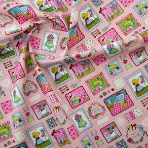 May include: Pink fabric with a repeating pattern of framed illustrations. The illustrations feature a girl in a dress, a sewing machine, a cat, and a rocking chair. The fabric has a polka dot background and the frames are decorated with flowers and buttons.