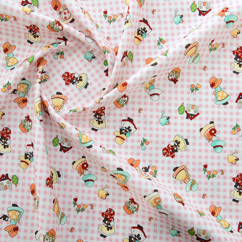 May include: Pink and white gingham fabric with a repeating pattern of black and white figures wearing red hats and carrying baskets. The figures are surrounded by small white flowers and green leaves.