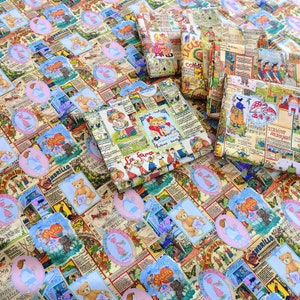 May include: A beige fabric with a repeating pattern of blue and pink circles containing illustrations of children and animals. The fabric features text in Spanish, including "La Fama" and "El Andorillo".