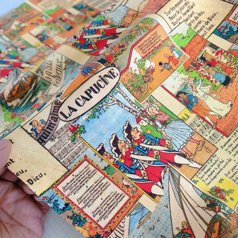 May include: A vintage fabric with a colorful comic book print featuring a scene of soldiers in a forest. The fabric has a light brown background with a blue sky and green trees. The text "quimaime LA CAPUCINE" is printed in a red and white font.