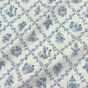 May include: Cream-coloured fabric with a blue toile de Jouy pattern. The design includes scenes of figures, flowers, and buildings within a floral trellis. The style is traditional and decorative.