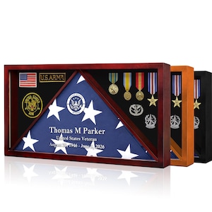 May include: A rectangular wooden display case containing a folded American flag, military medals, and patches. The flag features the text: Thomas M Parker, United States Veteran, August 20, 1946 - June 6, 2026. Three cases are shown in different wood finishes.