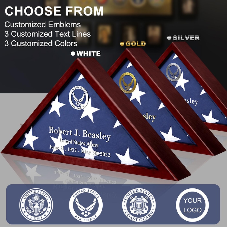 May include: A wooden triangular shadow box with a folded American flag inside. The box has a gold, silver, or white emblem on the front. The box is personalized with a name, branch of service, and dates of service. The box is available in three colors: gold, silver, and white.