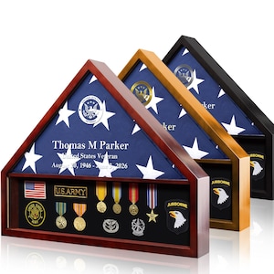 May include: Three triangular wooden display cases in cherry, oak, and black finishes. Each case holds a folded American flag with the text Thomas M Parker, United States Veteran, August 20, 1946 - June 3, 2026, and various military medals.