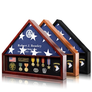 May include: Three wooden flag display cases with a blue and white star flag inside. The cases have a section for medals and patches. The text on the flag reads "Robert J. Beasley, United States Army, June 2, 1937 - May 30, 2022."