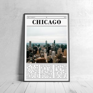 May include: A framed print featuring a photograph of the Chicago skyline. The word "CHICAGO" is printed in bold, black letters at the top. The image shows a cityscape with numerous skyscrapers under a cloudy sky. The print is displayed against a white wall.