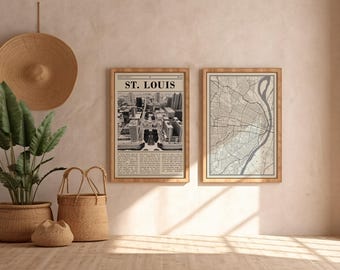 May include: Two framed prints with wooden frames hang on a wall. One print is a black and white aerial view of St. Louis with the text "ST. LOUIS" at the top. The other is a map of the city. A woven hat and baskets are in the foreground.