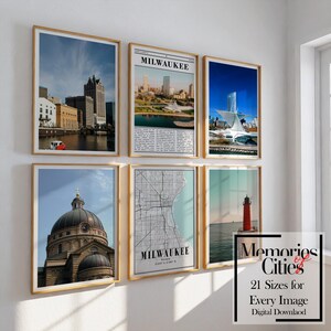 Könnte beinhalten: Eine Sammlung gerahmter Kunstdrucke mit Wahrzeichen und Stadtlandschaften von Milwaukee. Die Drucke zeigen Bilder von Gebäuden, einer Karte und einem Leuchtturm. Die Rahmen sind hellbraun und die Drucke werden an einer weißen Wand ausgestellt.
