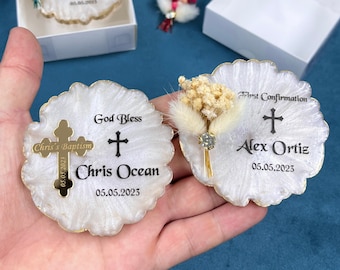 May include: Two white round resin coasters with gold trim and a cross design. The coasters have dried flowers and the text "God Bless + Chris Ocean 05.05.2023" and "First Confirmation + Alex Ortiz 05.05.2023".