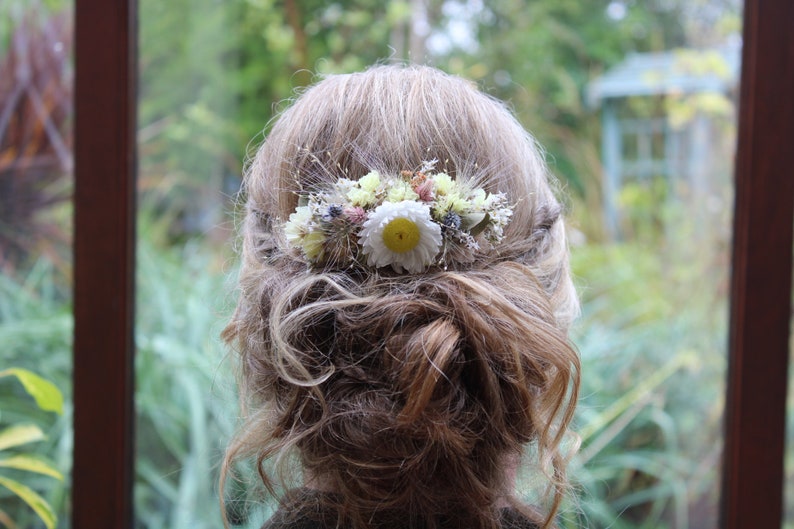 The yellow and white hair comb in an up do hair style.
