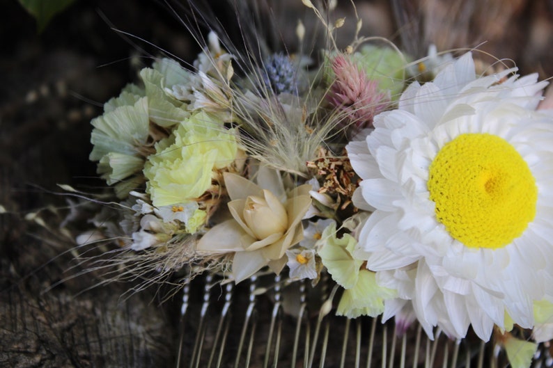 The flowers include a light lemon yellow statice, silvery cream straw flower heads,  perennial statice, pastel pink statice, blue thistle heads, pink flamingo celosia, bunny tail grass, eucalyptus leave and a single ...