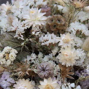 The white bridesmaid bouquet. The dried flowers res white straw flower, white achillea, poppy seed heads, scabiosa seed heads, white statice and nigella seed pods.