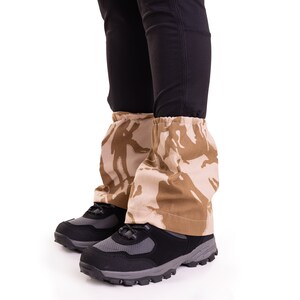 May include: A pair of black hiking boots with brown camouflage gaiters. The gaiters are made of a soft, durable fabric and are designed to protect your legs from the elements.
