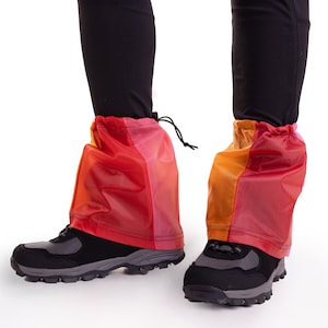 May include: A pair of colorful waterproof gaiters with a drawstring closure. The gaiters are made of a lightweight, breathable material and are designed to protect your legs from mud, snow, and other elements.