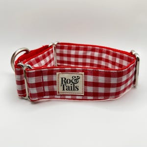 May include: Red and white gingham dog collar with silver hardware and a "Ro&Tails" label.