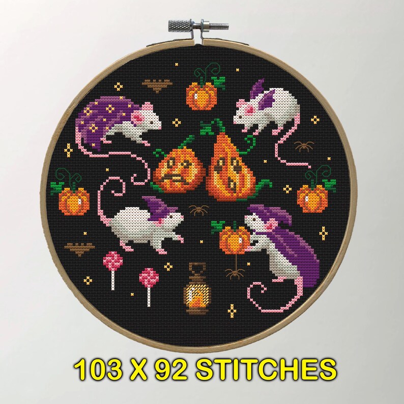 A cross-stitch design featuring white mice with purple capes interacting with pumpkins and other Halloween elements. The background is black, emphasizing the bright colors of the mice and pumpkins.