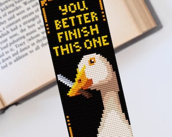 May include: A black and yellow bookmark with a white goose and the text "You better finish this one!"