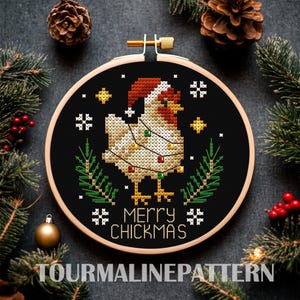 May include: A black embroidery hoop with a white chicken wearing a red Santa hat and Christmas lights. The text "Merry Chickmas" is written below the chicken.