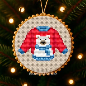 Christmas ornament cross stitch of a red sweater with a polar bear design in gold beaded round hoop on tree, TourmalinePattern on Etsy.