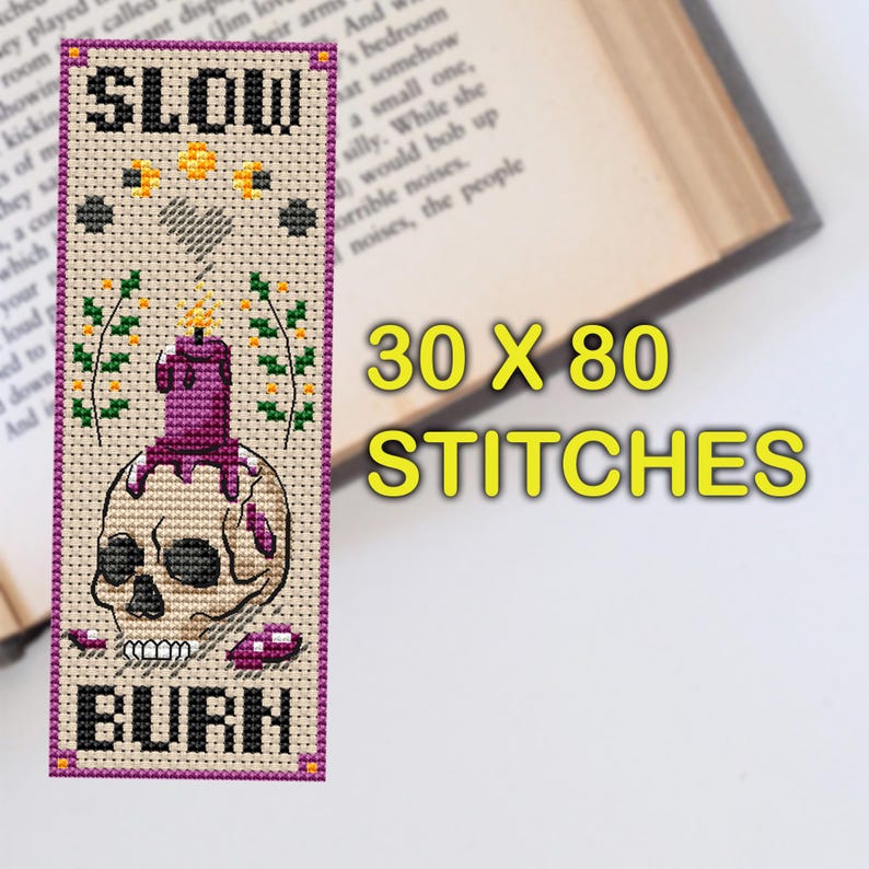 Cross stitch bookmark pattern on beige Aida with purple border: skull with a melting purple candle on top, wax drips, small flames, sprigs of flowers, stars, crescent moons, stitched heart, and text “SLOW BURN.” TourmalinePattern on Etsy.