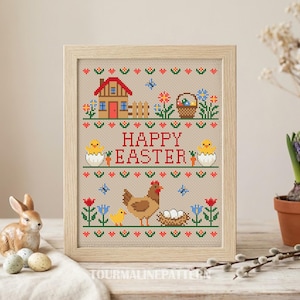 May include: Cross-stitch art in a wooden frame with a beige background. The design features a red house, flowers, a basket, and the words "HAPPY EASTER" in red. A hen, chick, and eggs are also depicted. A ceramic bunny and Easter eggs are in the foreground.