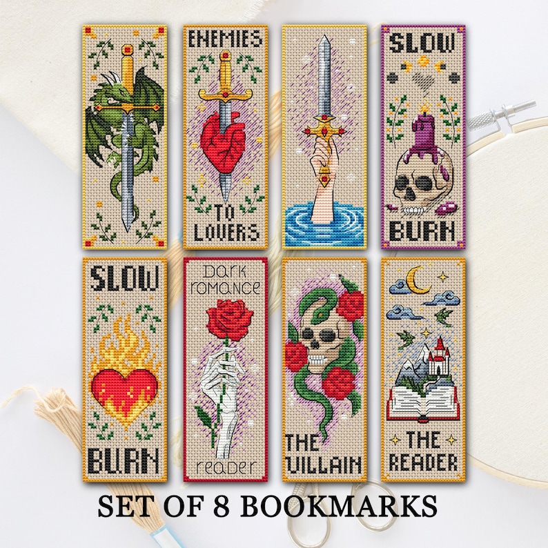 Set of 8 cross-stitch bookmarks on light Aida—dragon coiled around a sword; “Enemies to Lovers” with a dagger through a heart; a hand raising a jeweled sword from water; “Slow Burn” with a skull and melting candle; “Slow Burn” with a flaming heart; “Dark Romance Reader” with a skeleton hand holding a red rose; “The Villain” with a skull entwined by a green snake and red roses; “The Reader” with an open book, castle, moon, and stars. TourmalinePattern on Etsy.